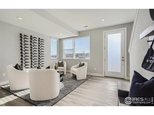 a living room with furniture window and a wooden floor