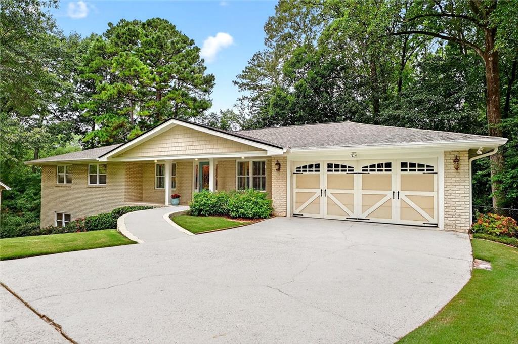 a view of a house with a yard and potted plants