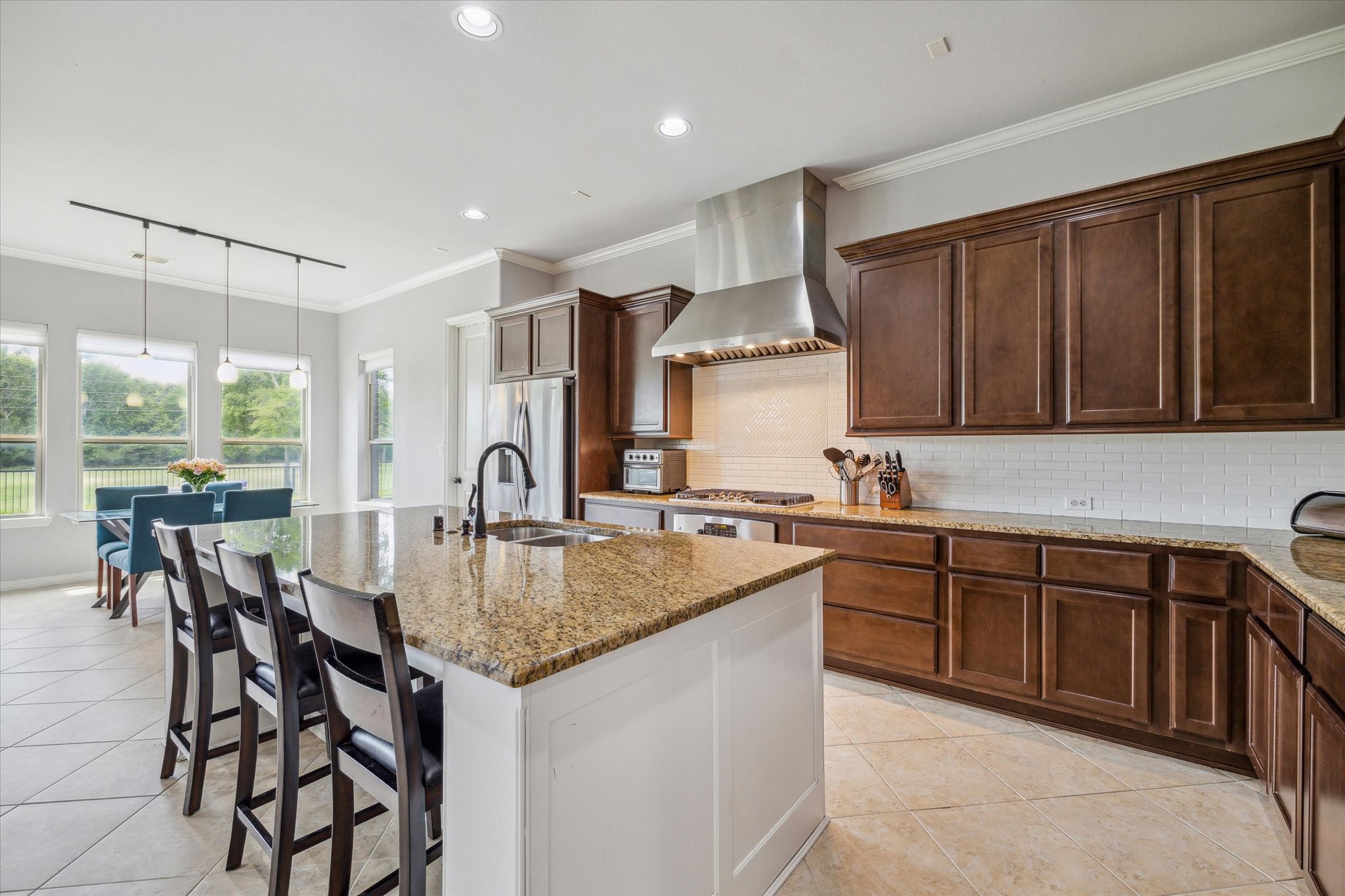 18531 Duke Lake Drive Spring, TX 77388 - Photo 15 of 41 a kitchen with stainless steel appliances granite countertop a stove top oven a sink dishwasher and cabinets with wooden floor