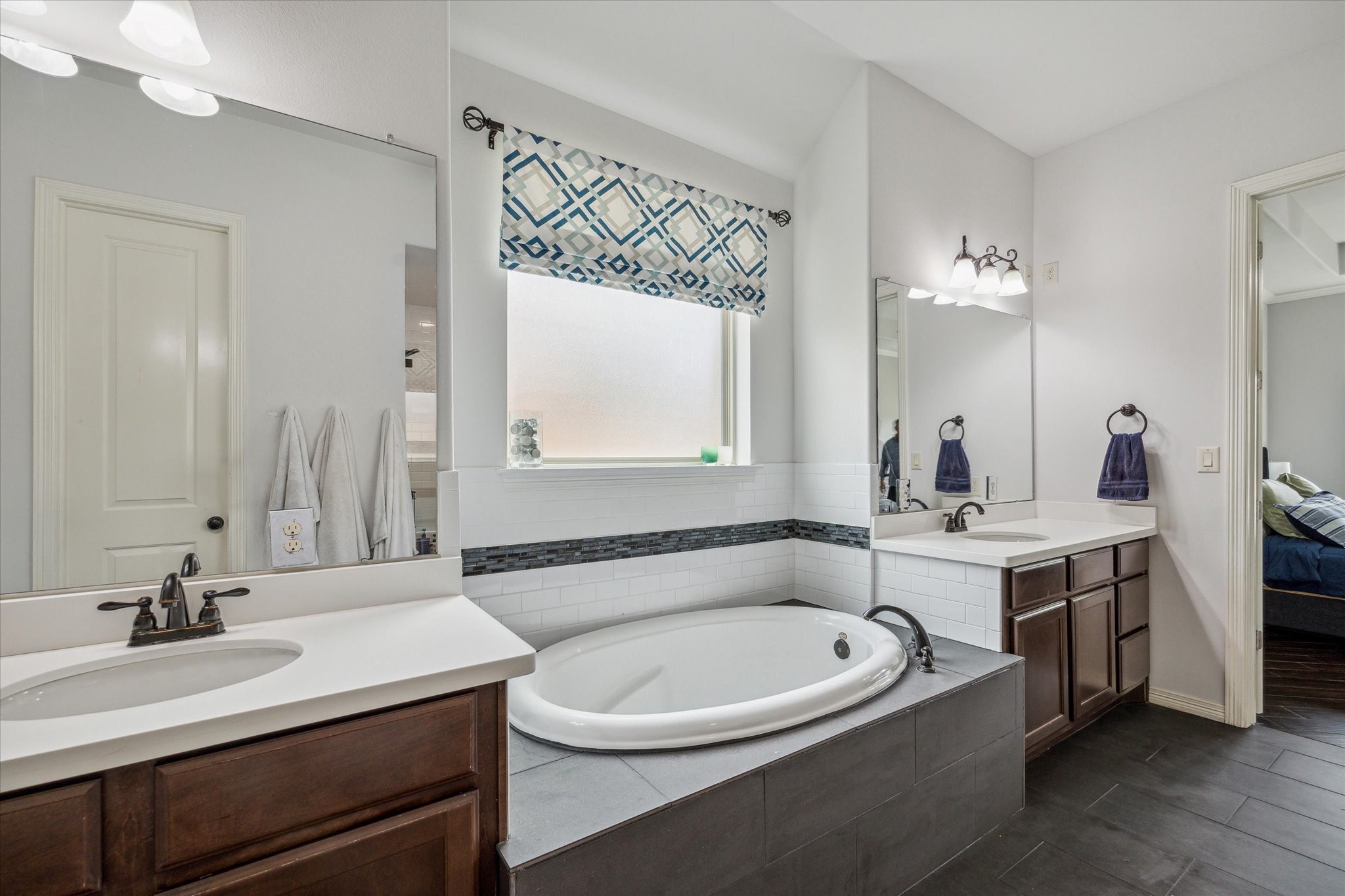 18531 Duke Lake Drive Spring, TX 77388 - Photo 22 of 41 a bathroom with a bathtub a double vanity sink and mirror