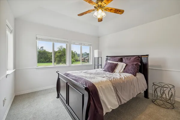 a bedroom with a bed and a chandelier