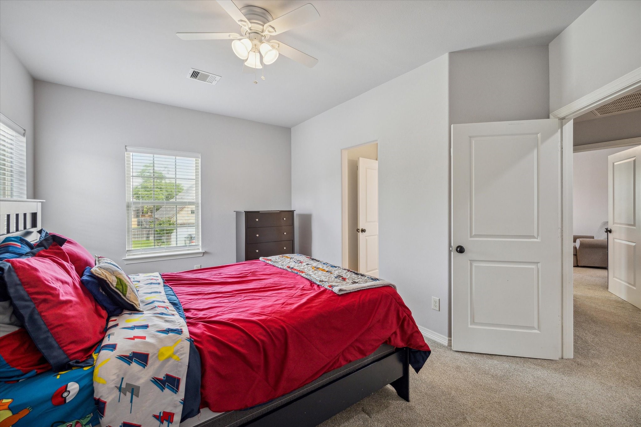 18531 Duke Lake Drive Spring, TX 77388 - Photo 26 of 41 a bedroom with a bed and a chandelier