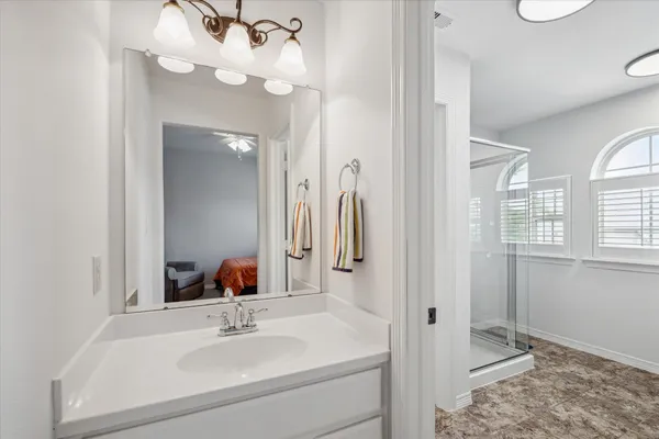 a bathroom with a sink vanity and a mirror