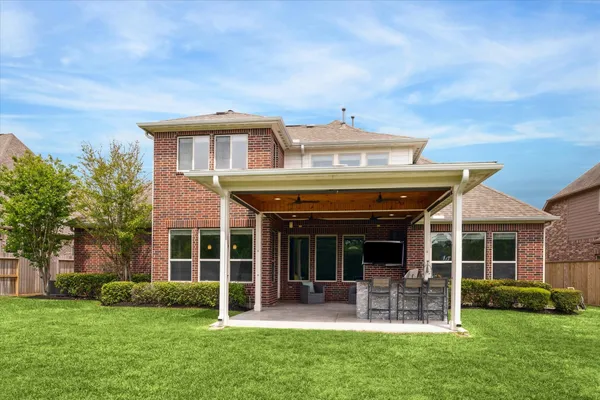 a view of a house with a yard and sitting area