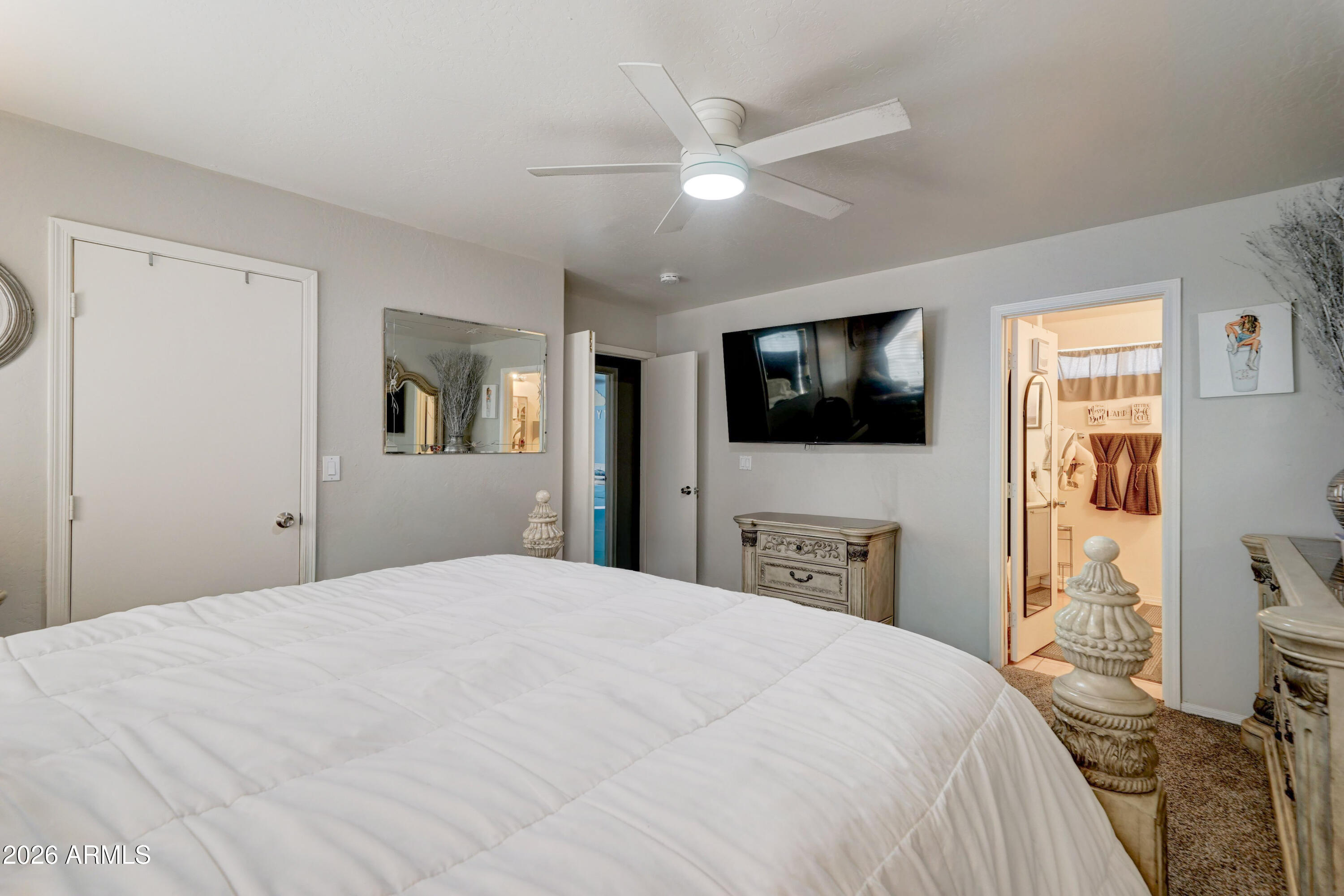 2744 South Raven Mesa, AZ 85209 - Photo 16 of 29 a bedroom with a bed and a flat tv screen on dresser