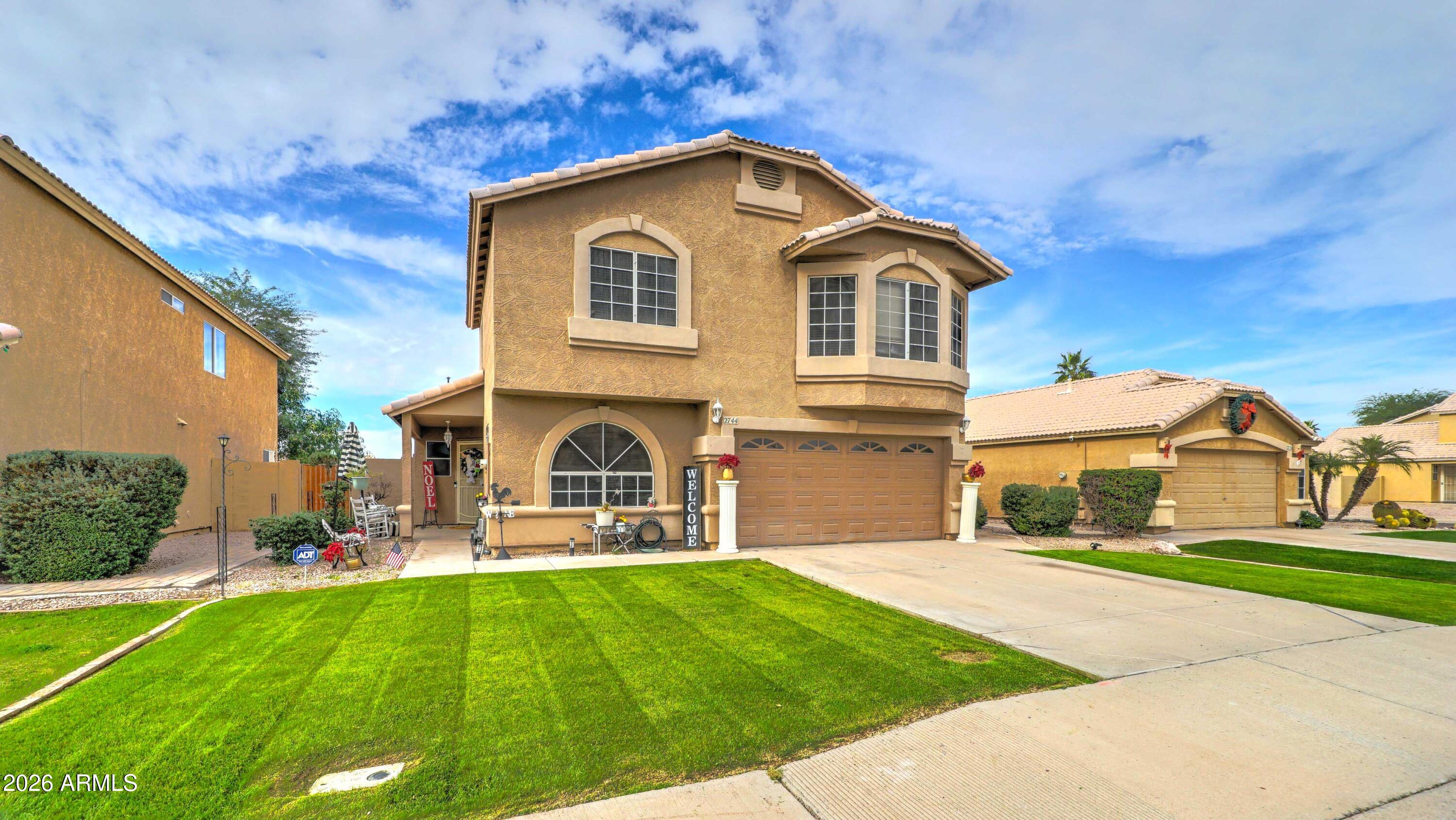 2744 South Raven Mesa, AZ 85209 - Photo 2 of 29 a front view of a house with a yard