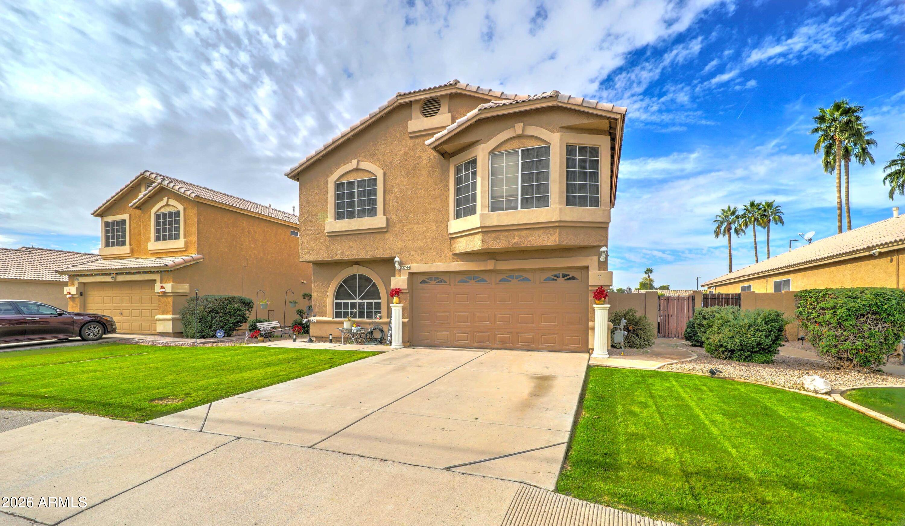 2744 South Raven Mesa, AZ 85209 - Photo 3 of 29 a front view of a house with a yard and potted plants