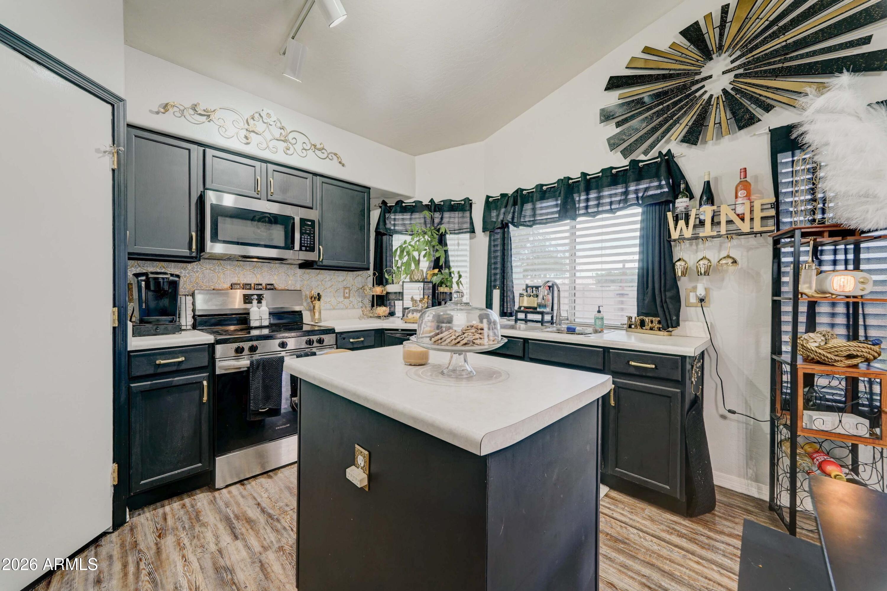 2744 South Raven Mesa, AZ 85209 - Photo 5 of 29 a kitchen with stainless steel appliances granite countertop a sink stove and refrigerator