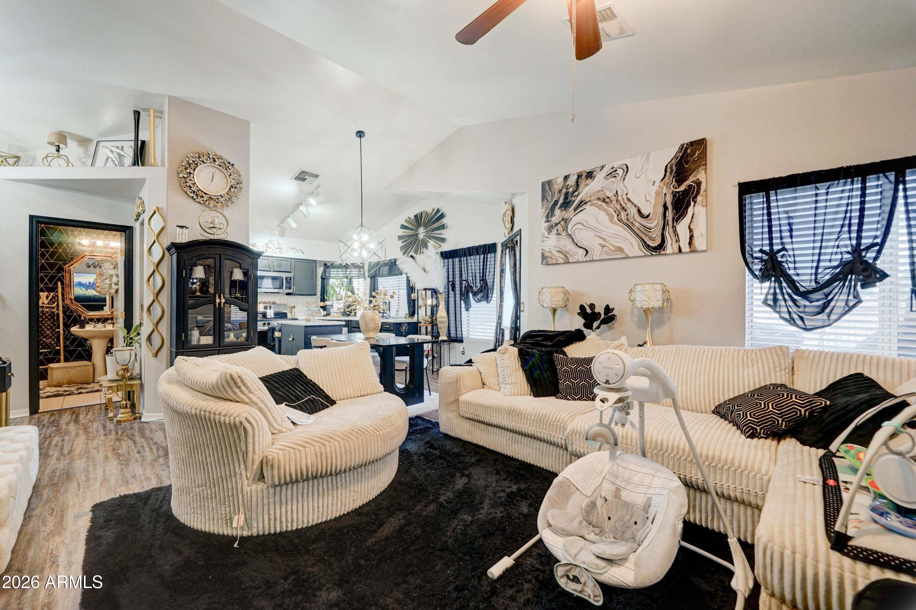 2744 South Raven Mesa, AZ 85209 - Photo 9 of 29 a living room with furniture and a chandelier