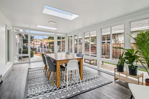 a view of a dining room with furniture and wooden floor