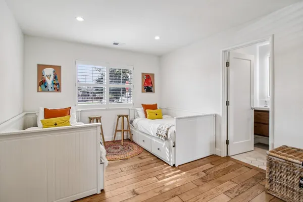 a room with white cabinets and clock on the wall