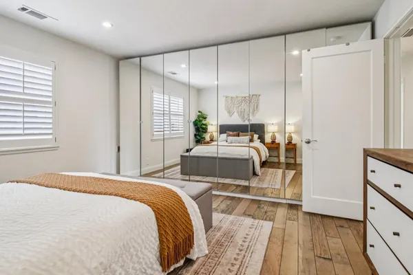 a bed room with a bed and a large mirror