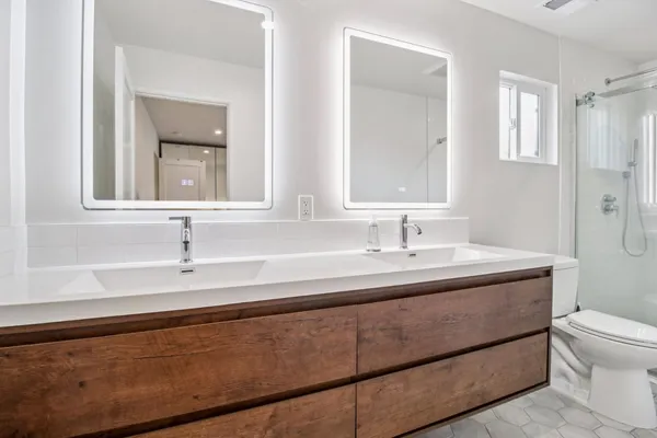 a bathroom with a sink toilet and shower