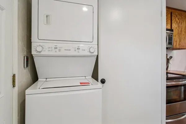 a room with lots of white walls and a floor to ceiling window