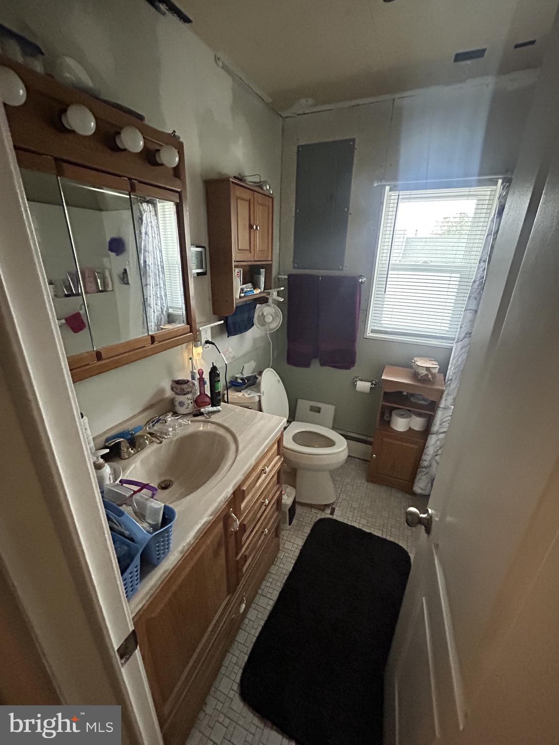 5948 Baltimore Street Baltimore, MD 21207 - Photo 16 of 32 a bathroom with a sink and a mirror