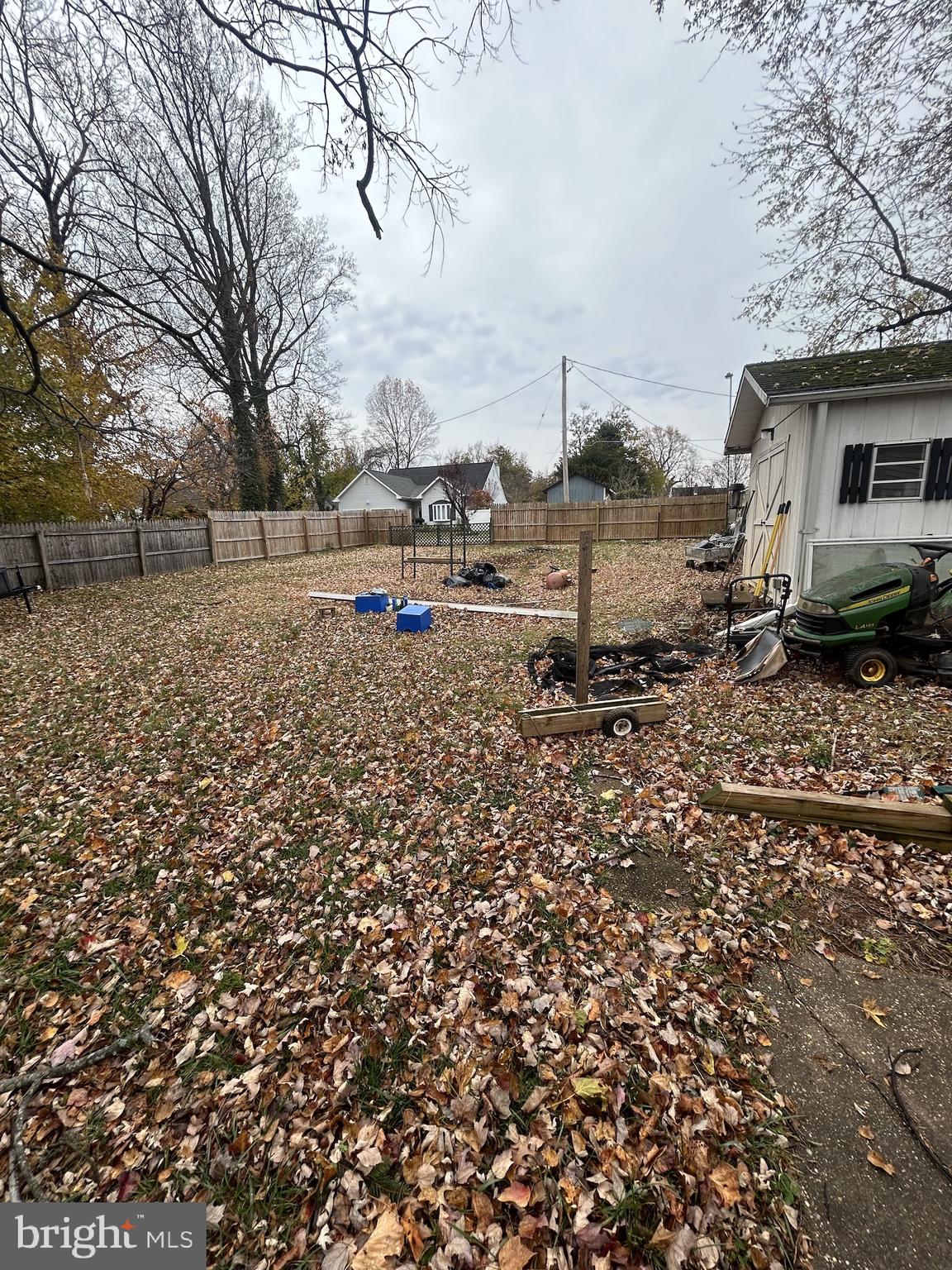 5948 Baltimore Street Baltimore, MD 21207 - Photo 10 of 32 a view of a old house next to a yard with large trees