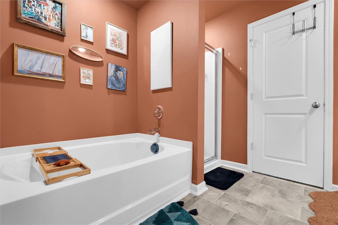 191 Light Spring Road Easley, SC 29642 - Photo 26 of 34 This bathroom features a deep soaking tub and a separate shower, creating a relaxing retreat.