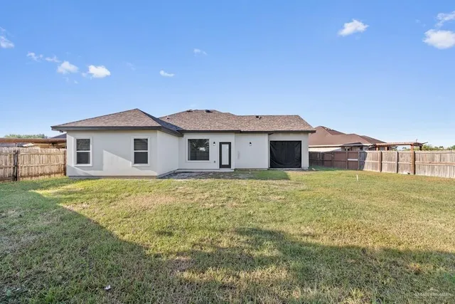 a view of a house with a backyard