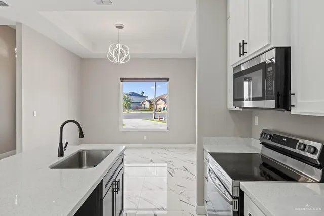 a kitchen with a refrigerator and a sink
