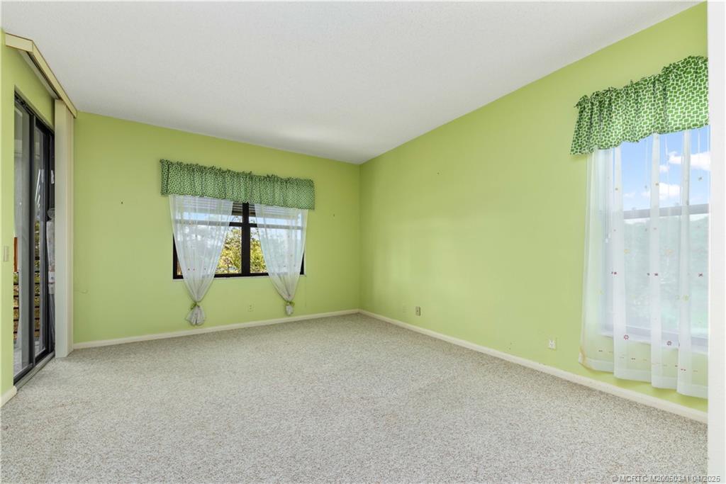 13464 Harbour Ridge Boulevard, Unit 8B Palm City, FL 34990 - Photo 14 of 33 a view of an empty room with a window