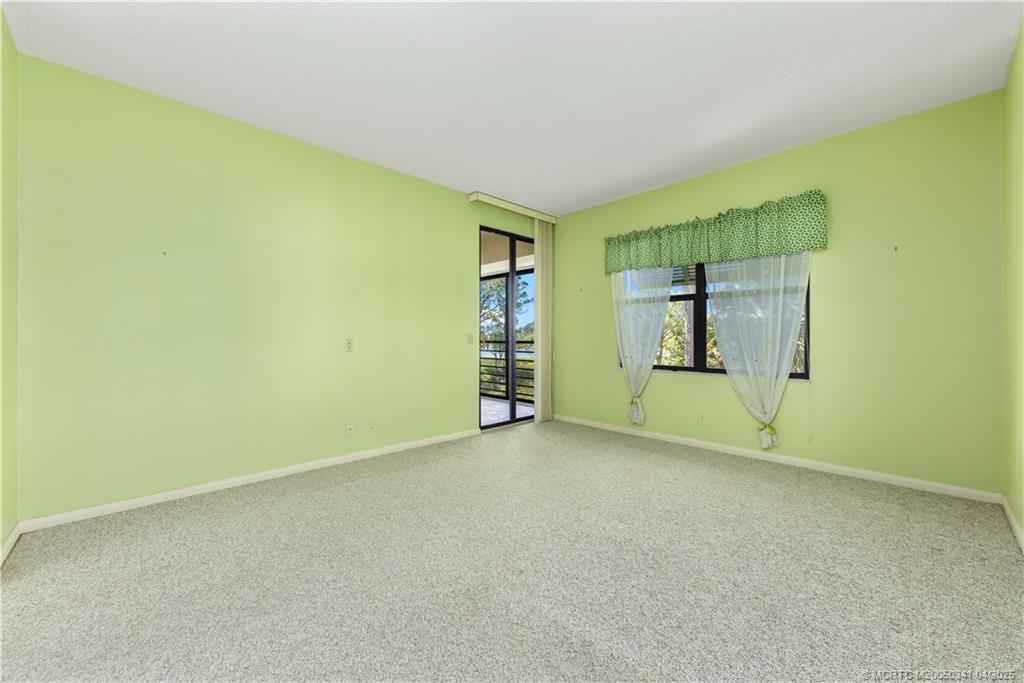 13464 Harbour Ridge Boulevard, Unit 8B Palm City, FL 34990 - Photo 15 of 33 an empty room with closet