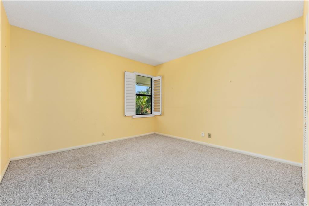 13464 Harbour Ridge Boulevard, Unit 8B Palm City, FL 34990 - Photo 19 of 33 an empty room with windows