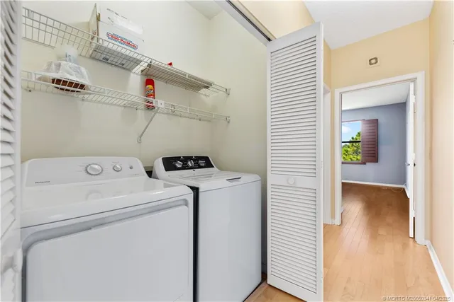 a view of storage and utility room with washer and dryer