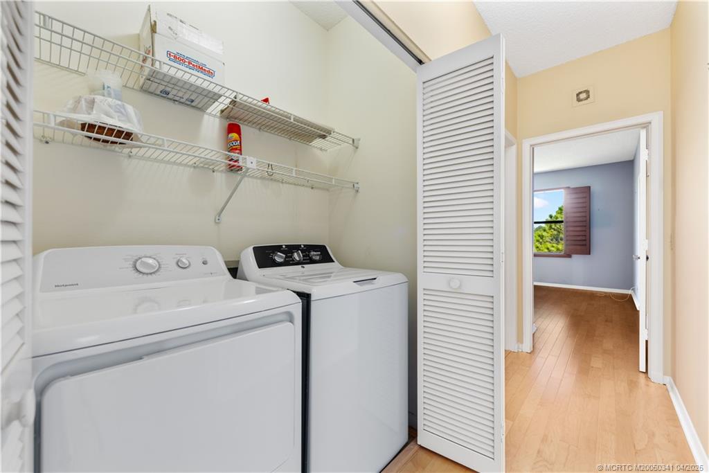 13464 Harbour Ridge Boulevard, Unit 8B Palm City, FL 34990 - Photo 23 of 33 a view of storage and utility room with washer and dryer