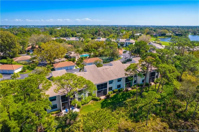 an aerial view of multiple house with a yard