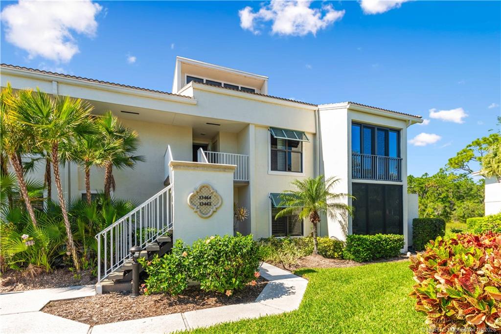 13464 Harbour Ridge Boulevard, Unit 8B Palm City, FL 34990 - Photo 3 of 33 a front view of a house with a yard