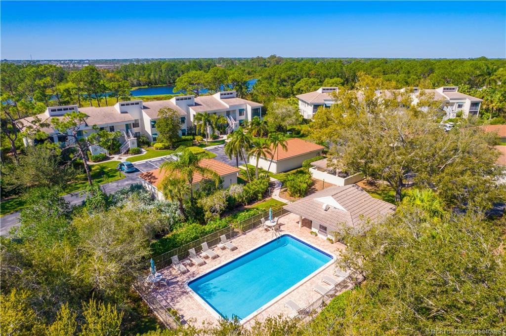 13464 Harbour Ridge Boulevard, Unit 8B Palm City, FL 34990 - Photo 33 of 33 an aerial view of residential houses with outdoor space and trees