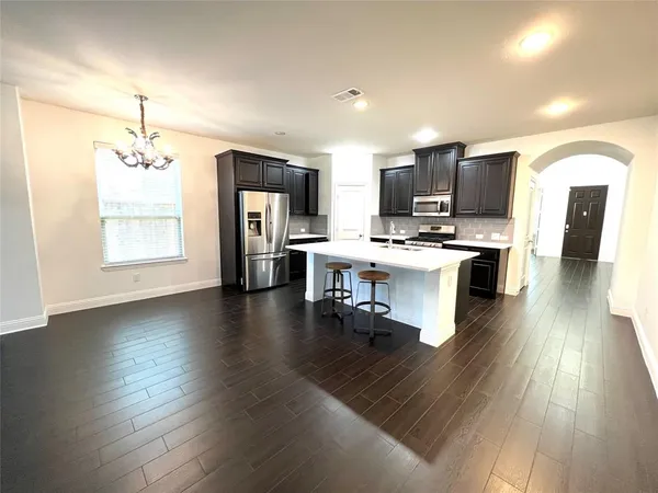 a kitchen with stainless steel appliances a refrigerator and a stove top oven