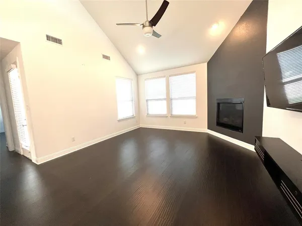 a view of a living room with kitchen view and wooden floor