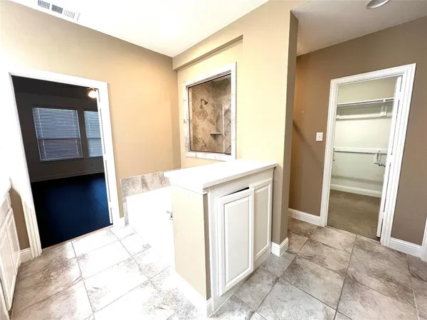a view of walk in closet with empty racks