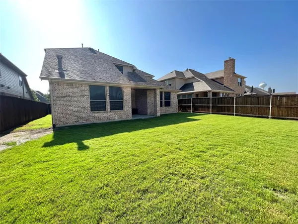 a view of a house with swimming pool and a yard