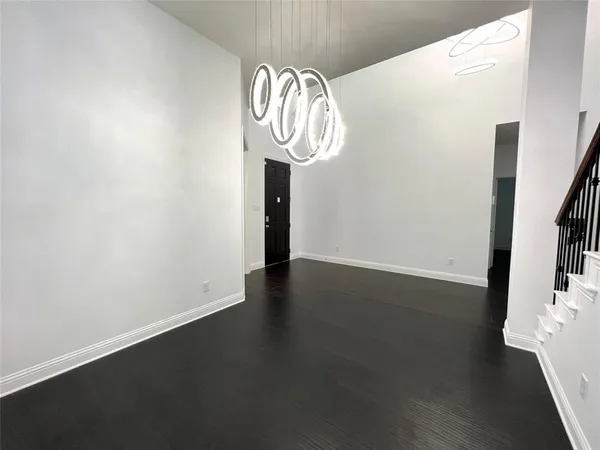 a view of room with wooden floor and windows