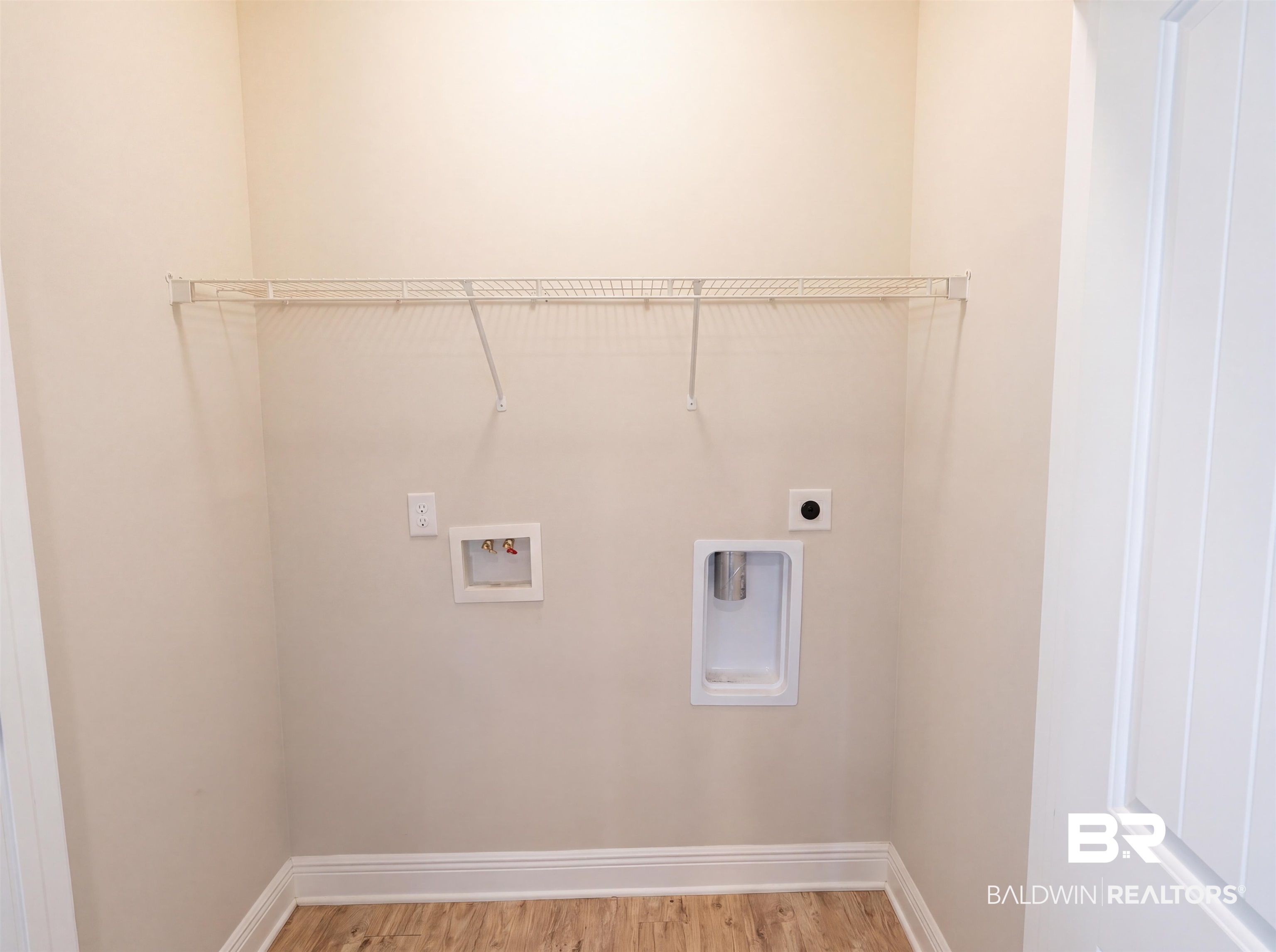 1740 Covington Lane Foley, AL 36535 - Photo 15 of 18 Dedicated utility space featuring wood-finish flooring and a wire shelving system
