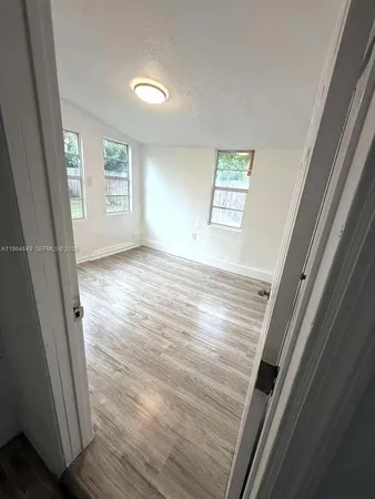 a view of an empty room and a window