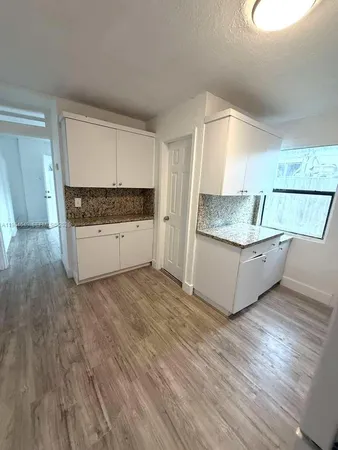 a kitchen with stainless steel appliances granite countertop a sink and a stove