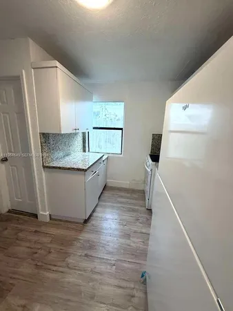a view of a kitchen cabinets and wooden floor