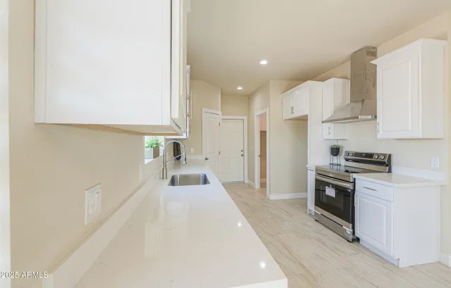 a view of a kitchen with a stove cabinets and a wooden floor