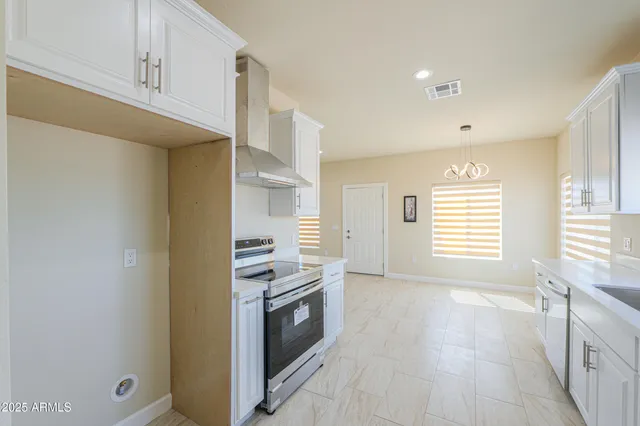 a kitchen with white cabinets and sink