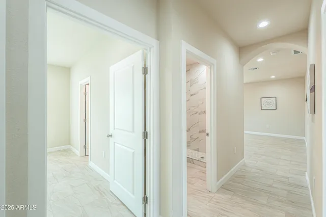 a view of an empty room with a window and a ceiling fan