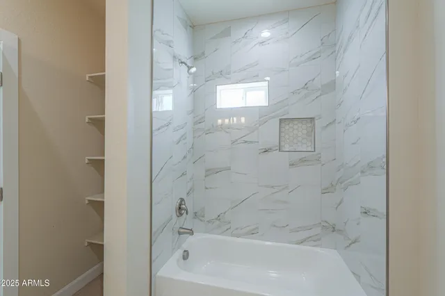 a view of a bathroom from a hallway