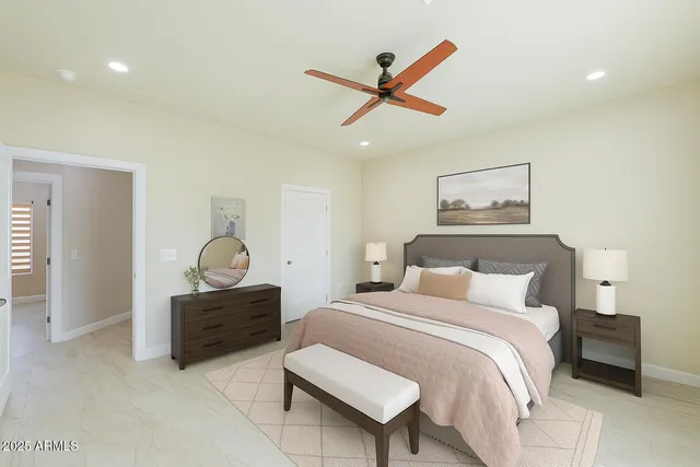 a bedroom with a bed couch and window