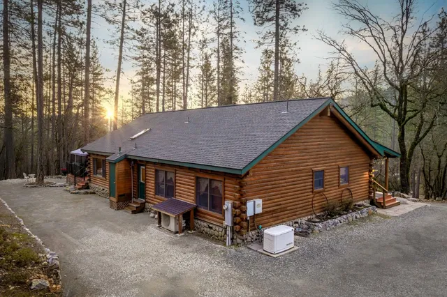 a backyard of a house with barbeque oven table and chairs