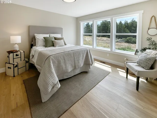 a bed sitting in a bedroom next to a window