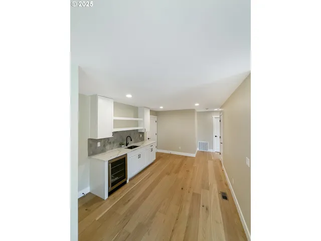 a open kitchen with cabinets and wooden floor
