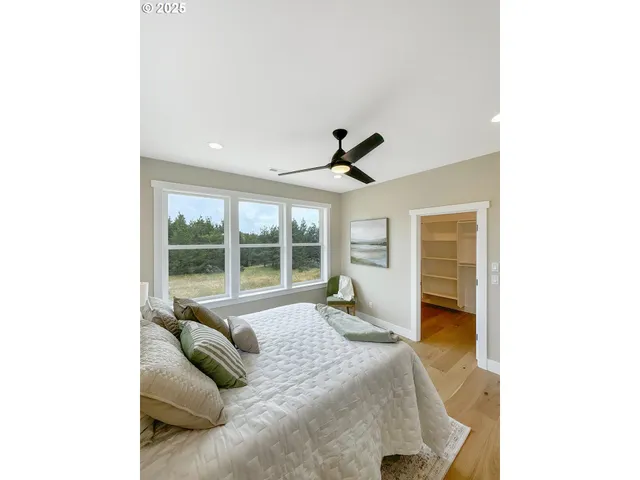 a bed room with a bed and a large window