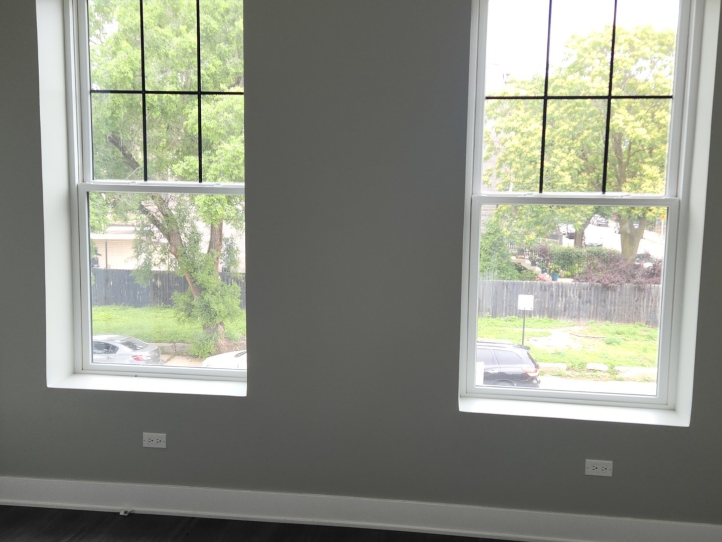 1023 East 45th Street, Unit 2 Chicago, IL 60653 - Photo 2 of 12 a view of an empty room with wooden floor and a window
